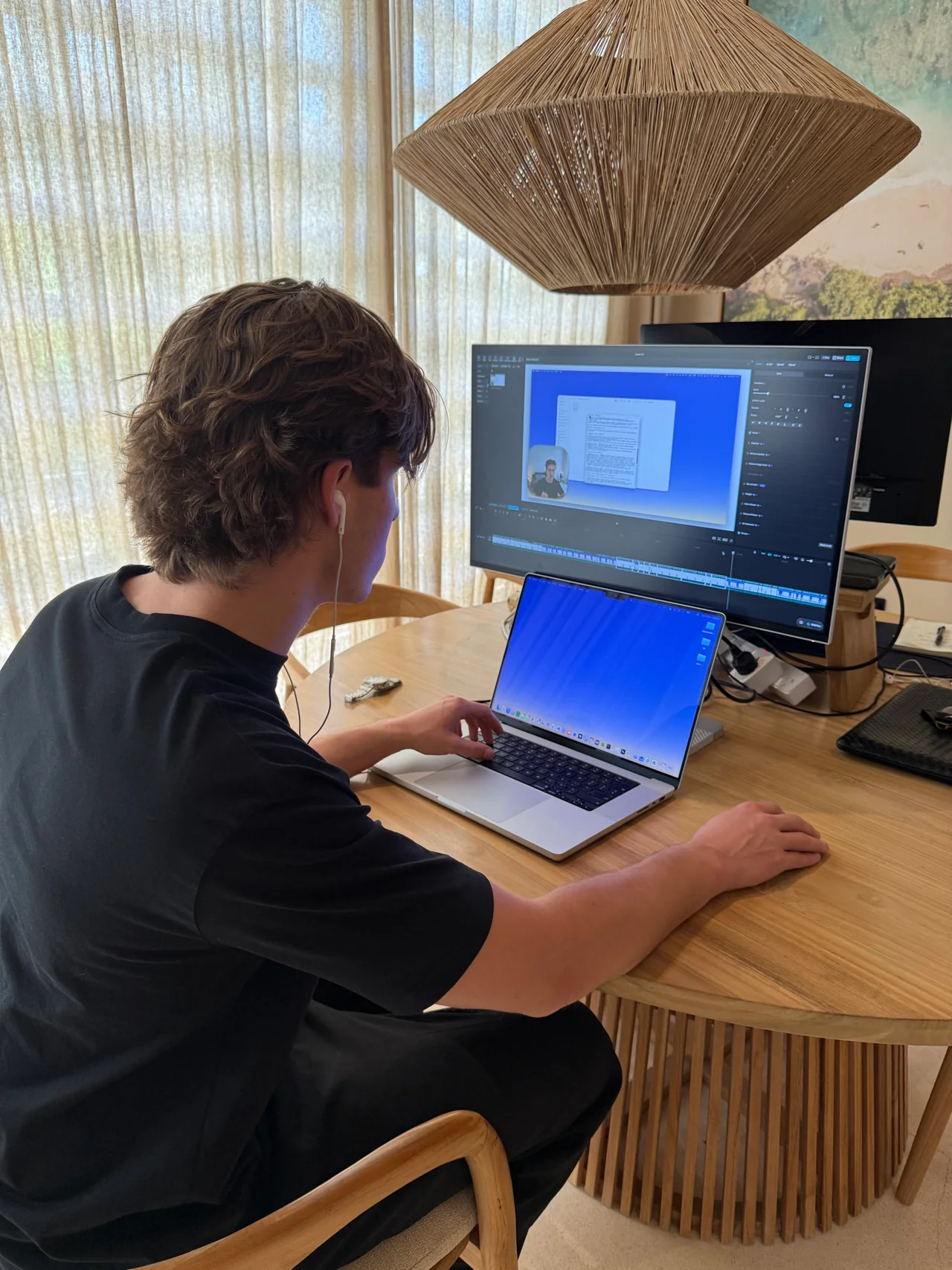 Remy at his desk, editing a lesson of The AI Course across a laptop and a monitor